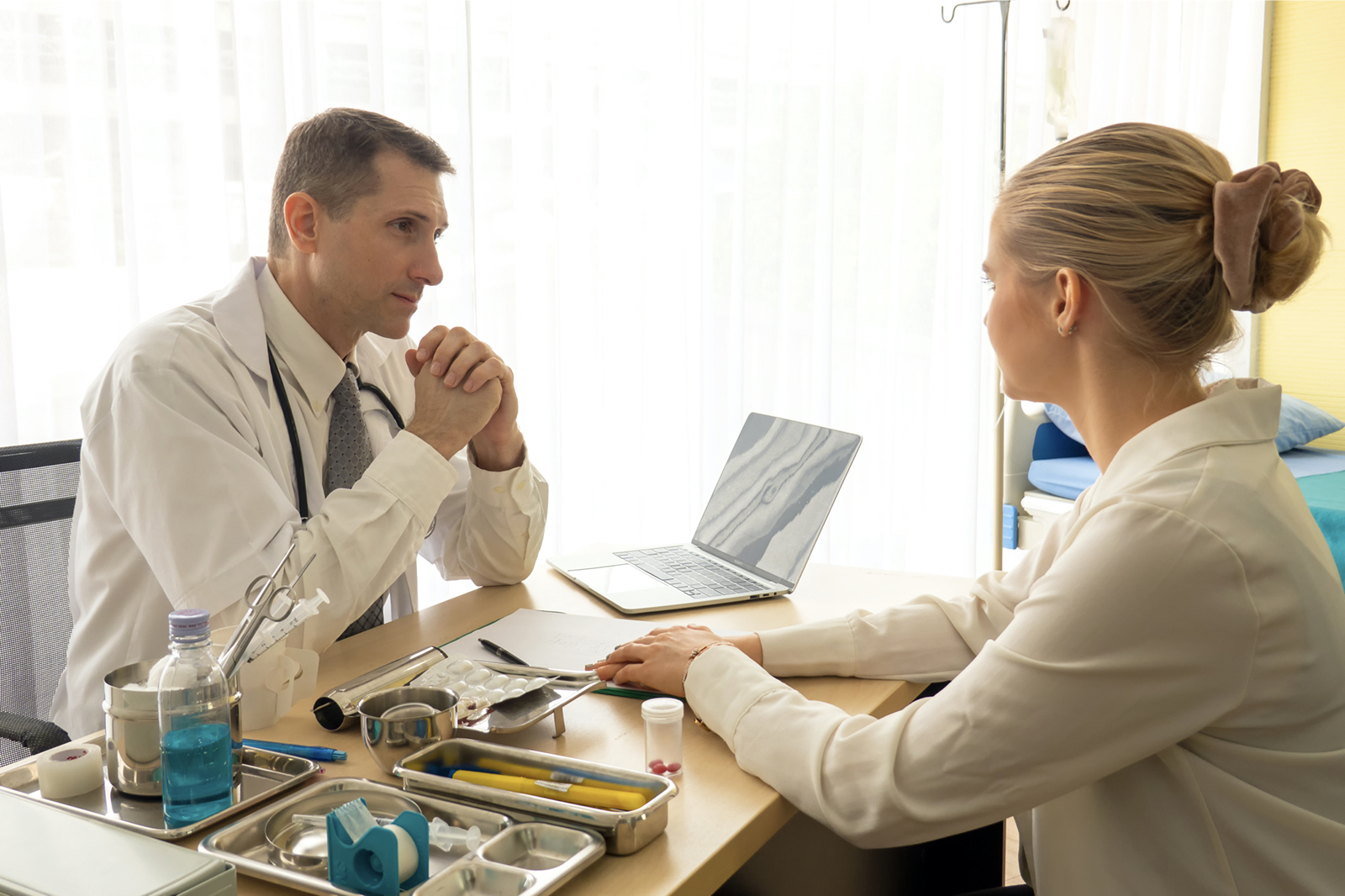 doctor explaining an x-ray to patient in clinic office